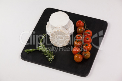 Cheese with cherry tomatoes and rosemary herb
