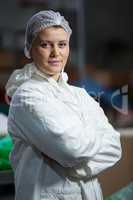 Female butcher standing with arms crossed