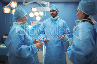 Team of surgeons having discussion in operation theater