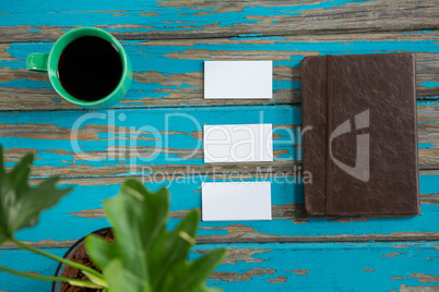 Coffee, diary with sticky notes on wooden table