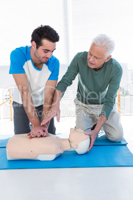 Paramedic training cardiopulmonary resuscitation to man