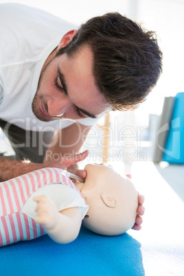 Paramedic practising resuscitation on dummy