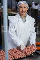 Butcher packing raw sausages