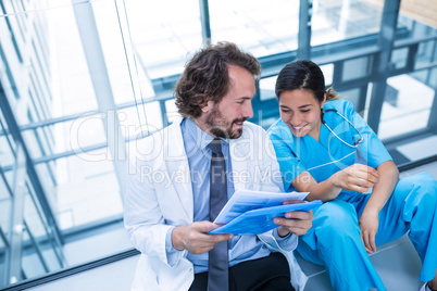 Happy doctor and nurse discussing over a report