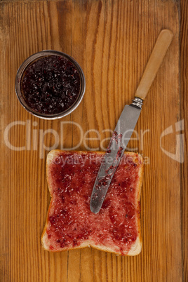 Bread with jam and knife