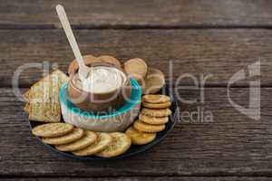 Cheese sauce with biscuits in black plate