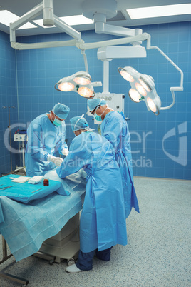Team of surgeons performing operation in operation theater