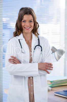 Portrait of a smiling female doctor standing with arms crossed Portrait of a smiling female doctor standing with arms crossed