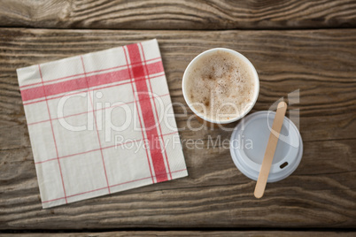 Coffee in disposable cup with tissue paper
