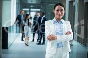 Businesswoman standing with her arms crossed