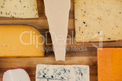 Cheese with knife on chopping board
