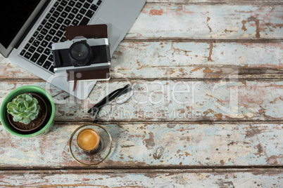 Laptop, camera and diary with coffee cup