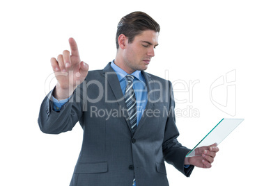 Businessman holding a futuristic digital tablet and touching an digital screen