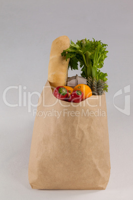 Fruits and vegetables in brown grocery bag