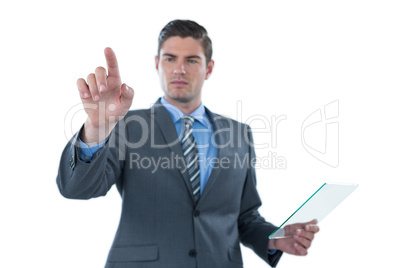 Businessman holding a futuristic digital tablet and touching an digital screen