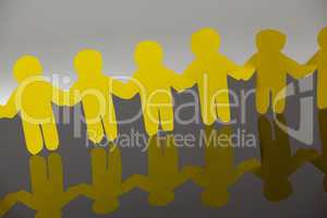 Paper cut outs forming a human chain
