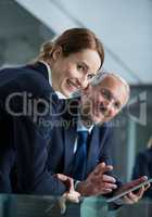 Businessman with colleague using digital tablet