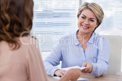 Doctor giving prescription to patient