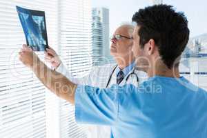 Surgeon and doctor discussing x-ray report