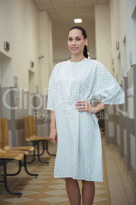 Portrait of female patient standing in corridor