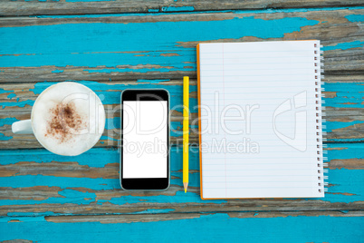 Coffee, smartphone and notepad with pencil