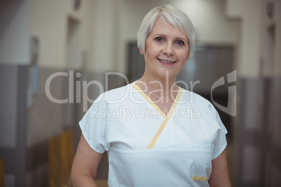 Portrait of female nurse standing in corridor