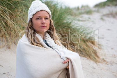 Thoughtful woman wrapped in shawl