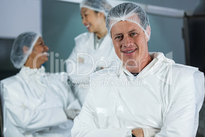 Smiling butcher standing with arms crossed