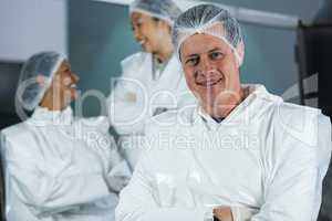 Smiling butcher standing with arms crossed