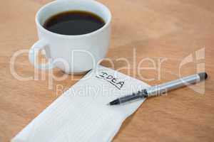Black coffee with idea written on tissue paper