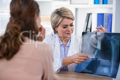 Female doctor explaining x-ray report to patient