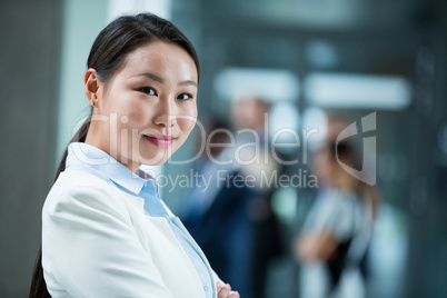 Confident businesswoman standing with her arms crossed