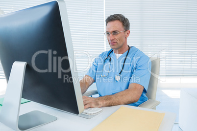 Surgeon working on personal computer