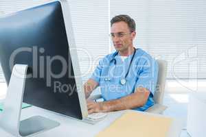 Surgeon working on personal computer