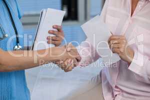 Doctor shaking hands with patient