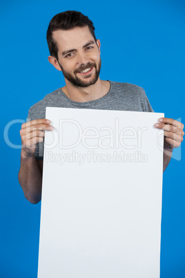 Handsome man holding a blank placard Handsome man holding a blank placard
