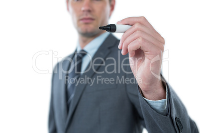 Businessman pretending to write with marker on an invisible screen