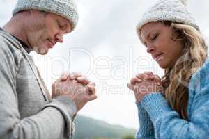 Couple praying with hands clasped