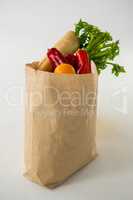 Fruits and vegetables in brown grocery bag