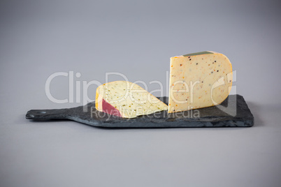 Pieces of cheese on chopping board