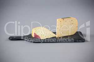Pieces of cheese on chopping board