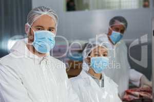 Butchers in protective workwear at meat factory