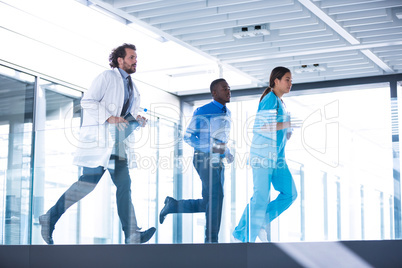 Businessman, doctor and nurse in hospital corridor