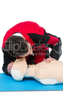 Paramedic practising resuscitation on dummy