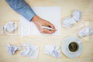 Graphic designer writing on paper