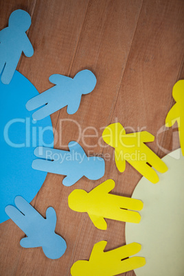Blue and yellow paper cut-out people on the circle