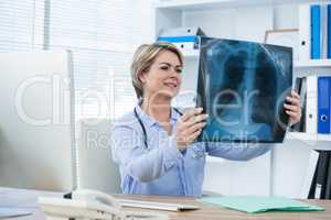 Female doctor examining x-ray report