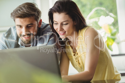 Happy couple using laptop