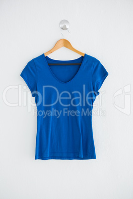 Blue t-shirt hanging on wall