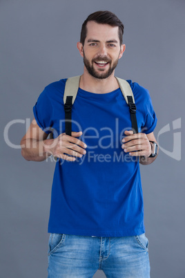 Happy man in blue t-shirt with backpack